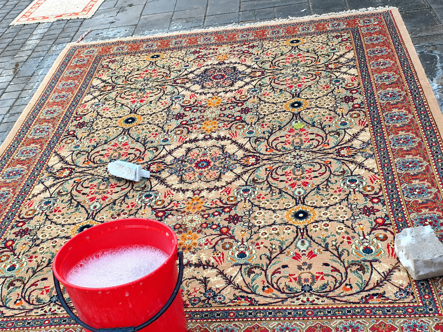 Persian carpet being professionally cleaned by hand